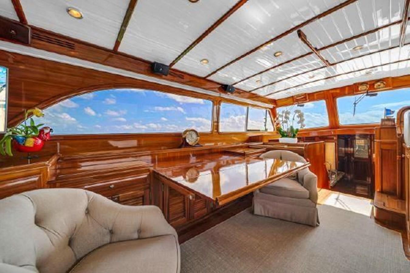 a large room with a large wood staircase and a large window aboard TRUANT Yacht for Sale