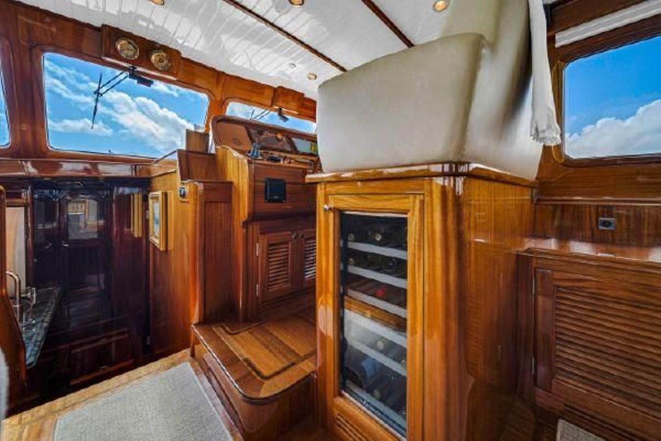 a room with wooden furniture aboard TRUANT Yacht for Sale