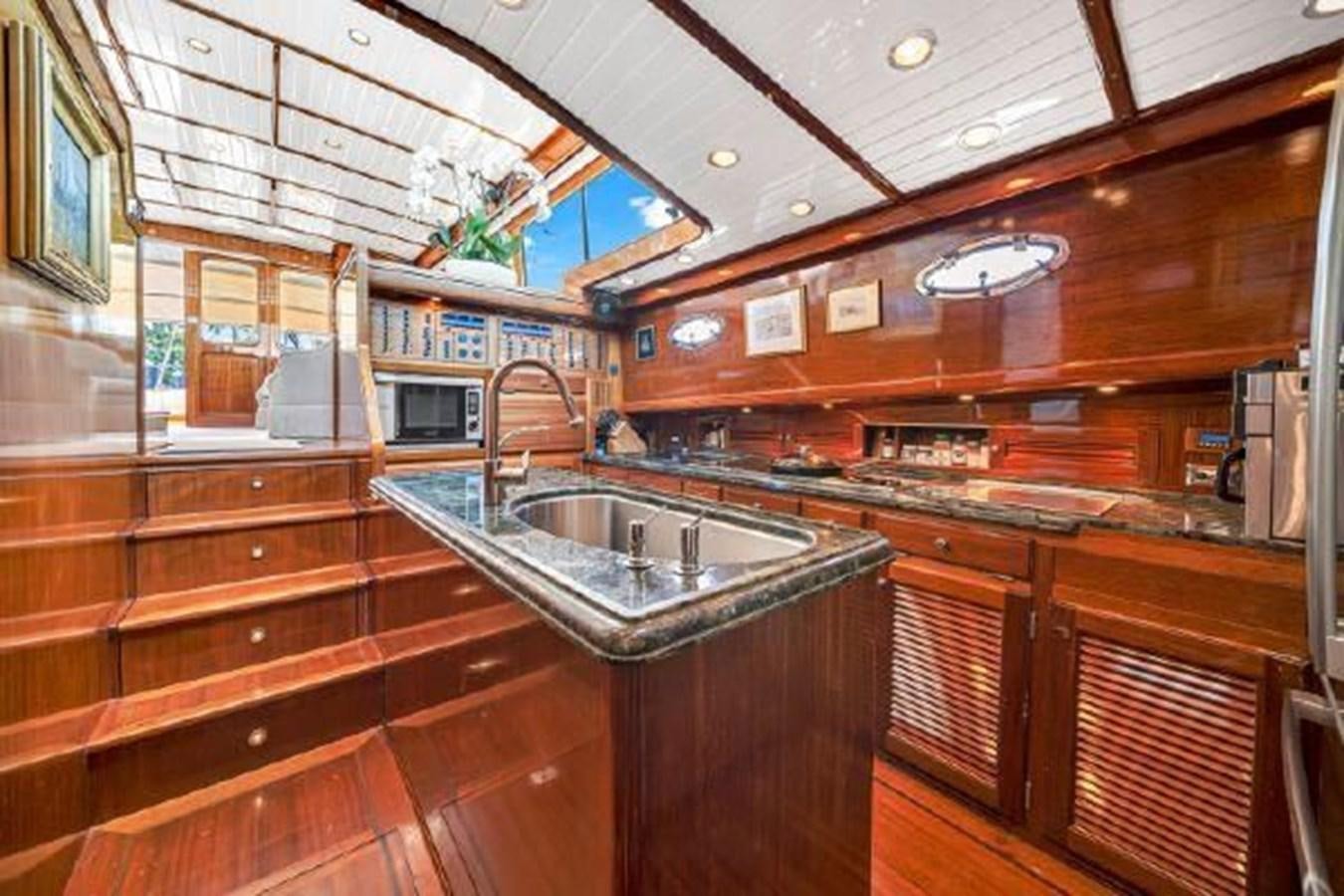 a kitchen with wooden cabinets aboard TRUANT Yacht for Sale