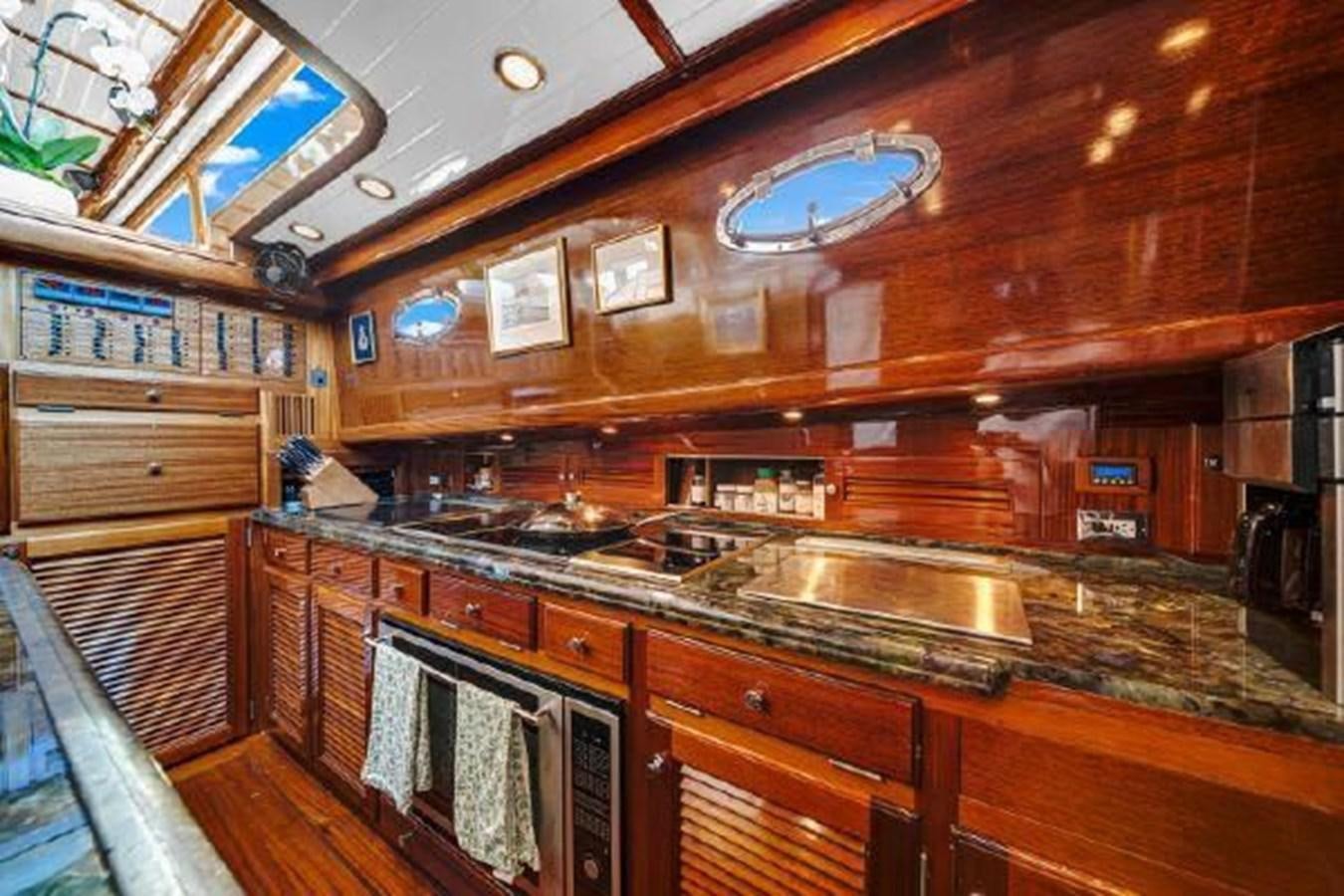 a kitchen with wooden cabinets aboard TRUANT Yacht for Sale