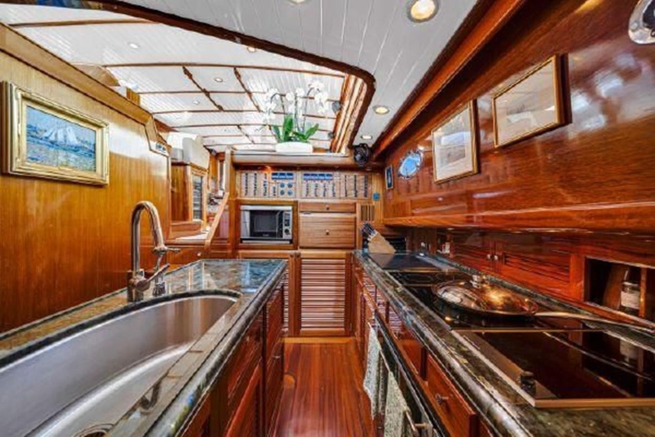 a kitchen with wooden cabinets aboard TRUANT Yacht for Sale