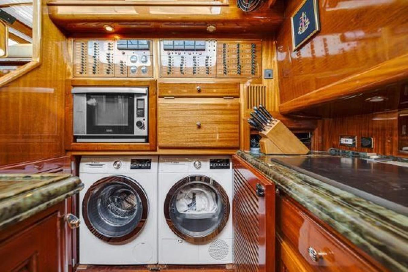 a kitchen with a washing machine and dryer aboard TRUANT Yacht for Sale