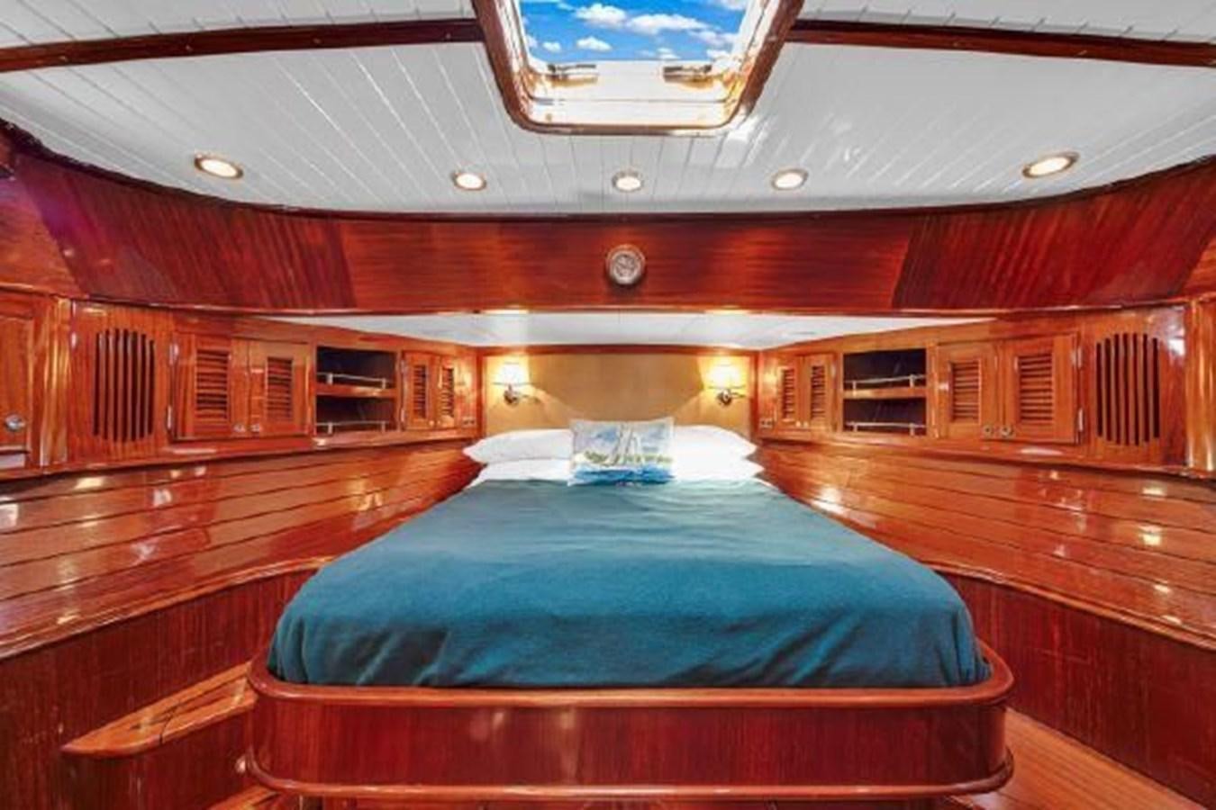 a room with a bed and a wood wall aboard TRUANT Yacht for Sale