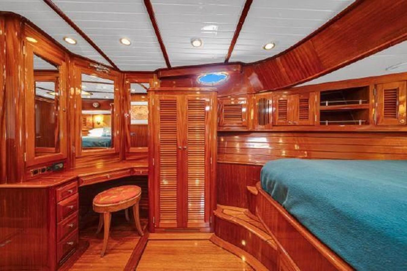 a cabin with a bed and a chair aboard TRUANT Yacht for Sale