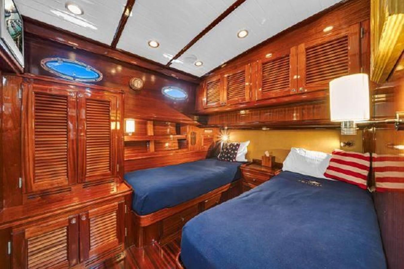 a room with wooden furniture aboard TRUANT Yacht for Sale