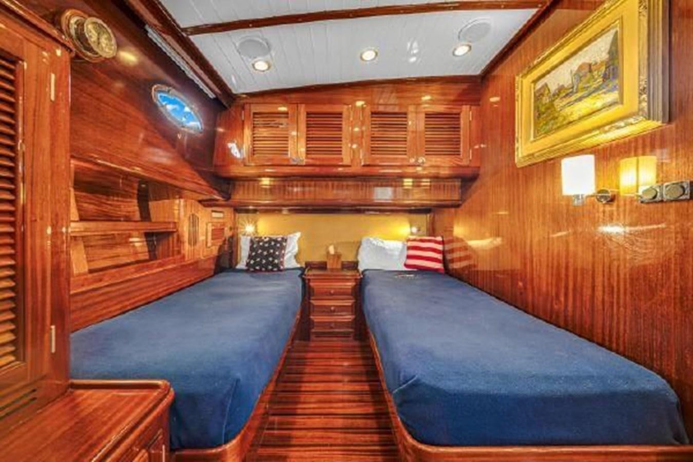 a room with a bed and a wood wall aboard TRUANT Yacht for Sale