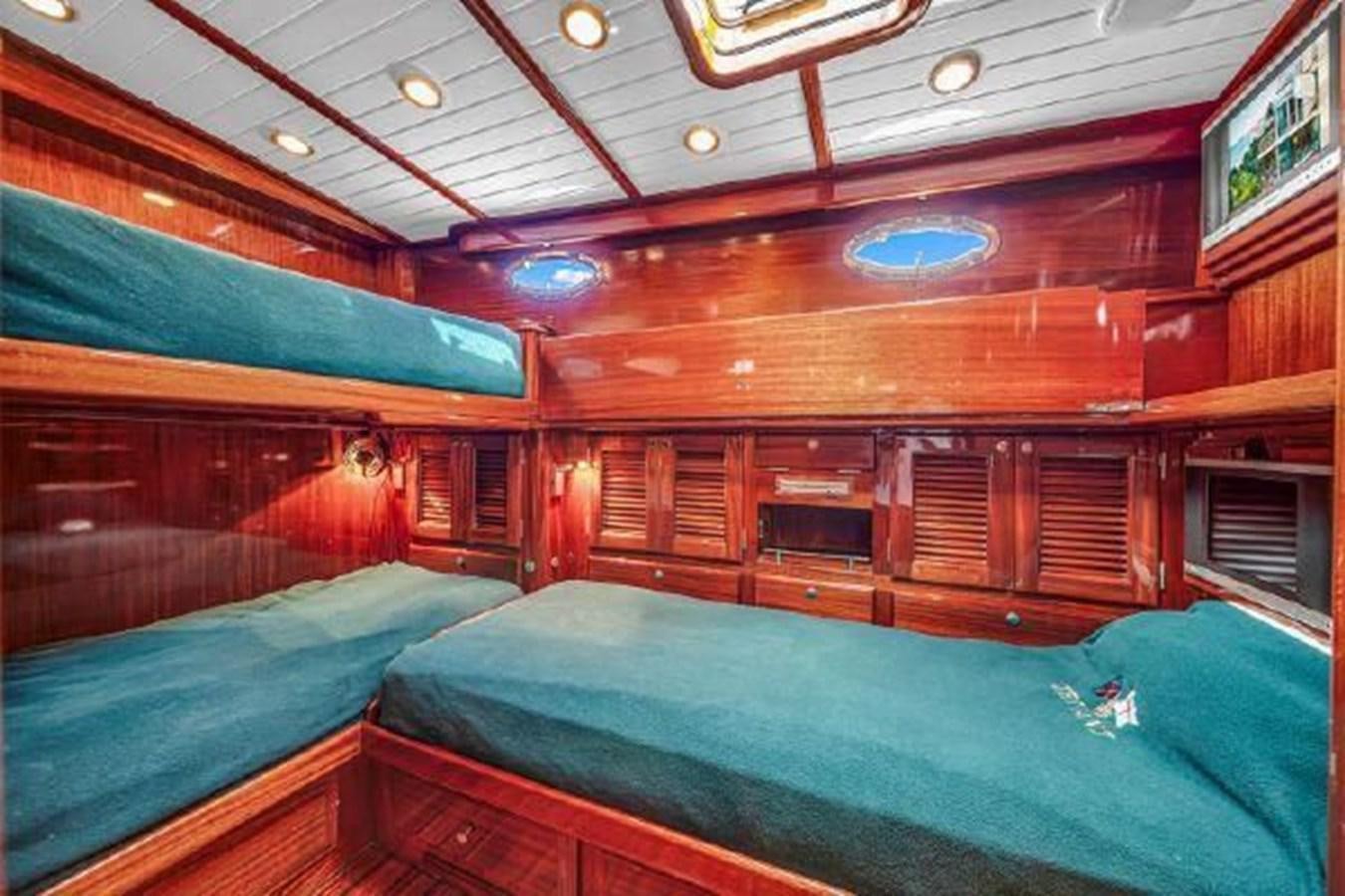 a room with a bed and a window aboard TRUANT Yacht for Sale