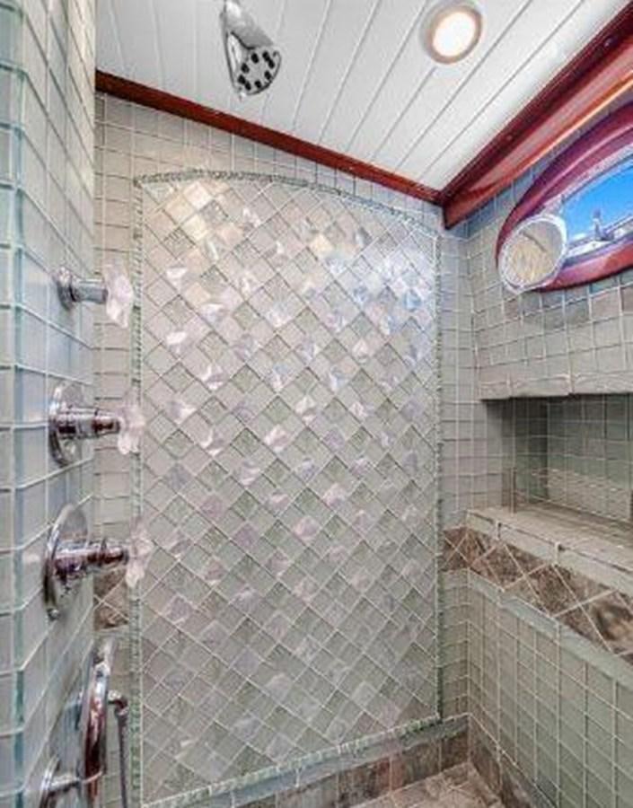 a shower with a tile wall aboard TRUANT Yacht for Sale
