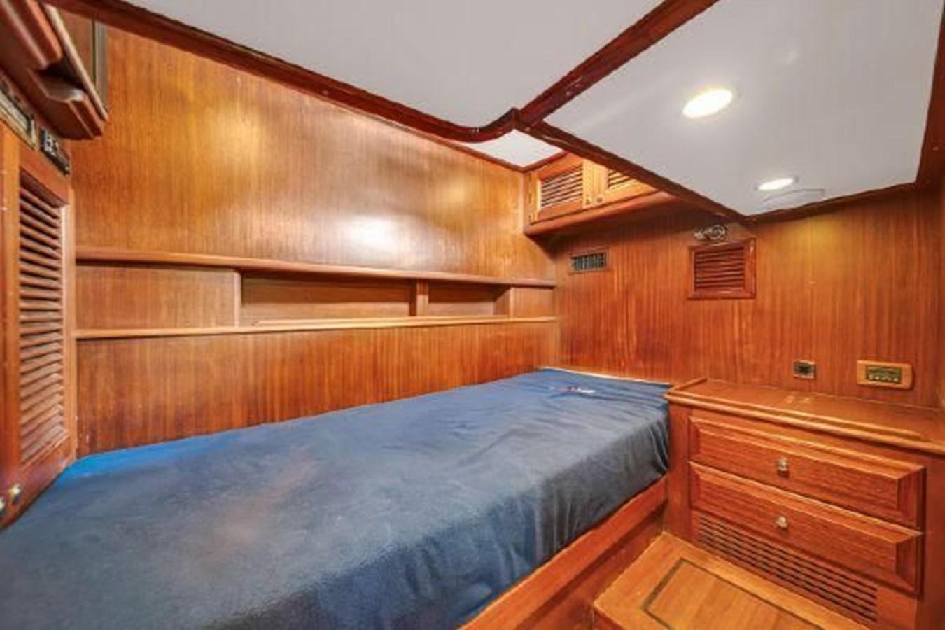 a room with wooden walls and wooden furniture aboard TRUANT Yacht for Sale