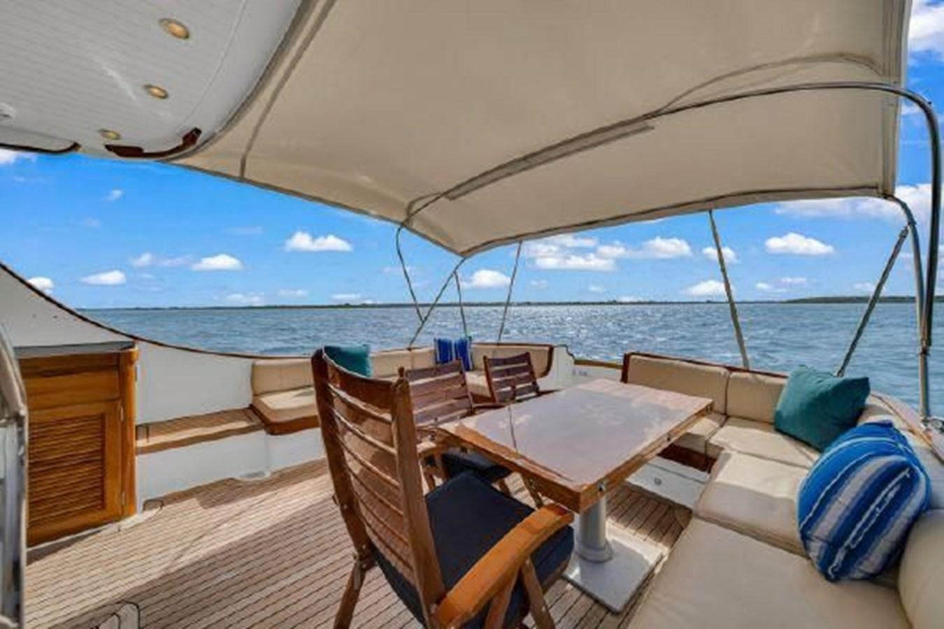 a deck with chairs and tables on it aboard TRUANT Yacht for Sale