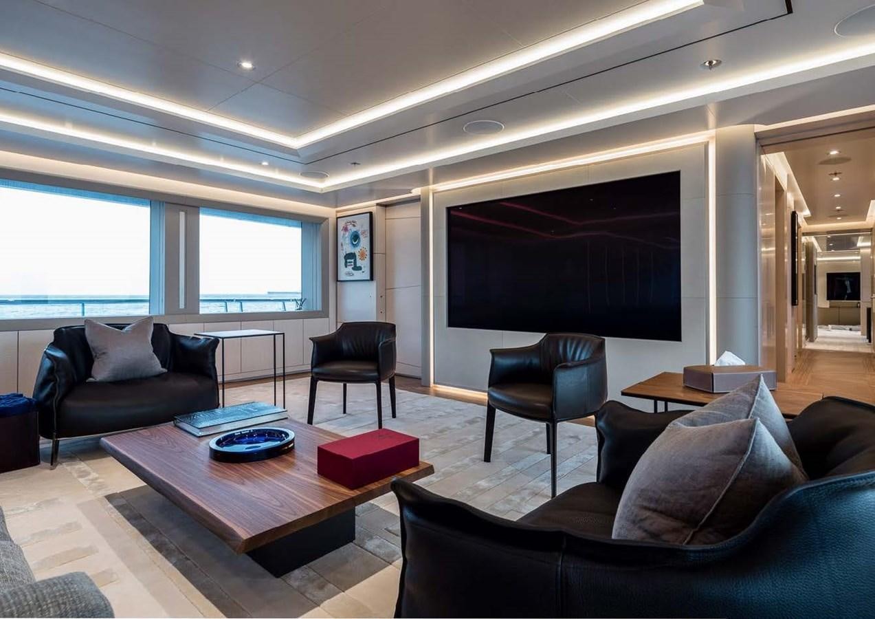 a living room with a large screen aboard STELLA MI Yacht for Sale