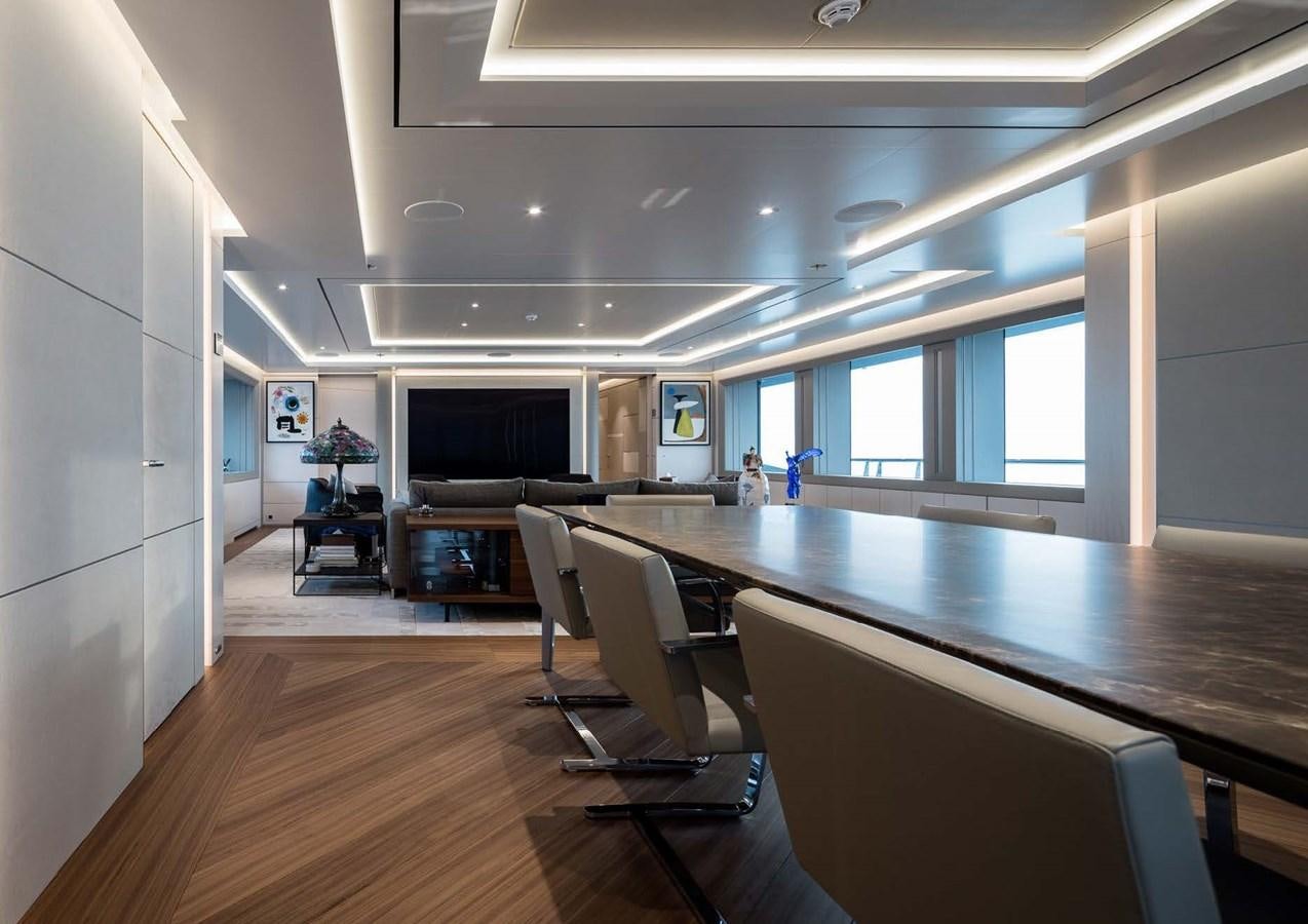 a large room with a table and chairs aboard STELLA MI Yacht for Sale