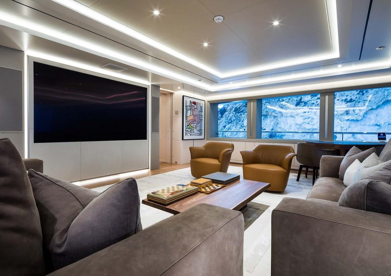 a living room with a large screen aboard STELLA MI Yacht for Sale