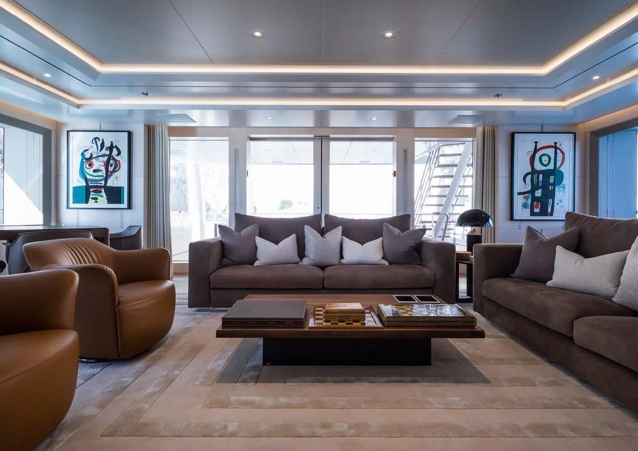 a living room with a table and couches aboard STELLA MI Yacht for Sale