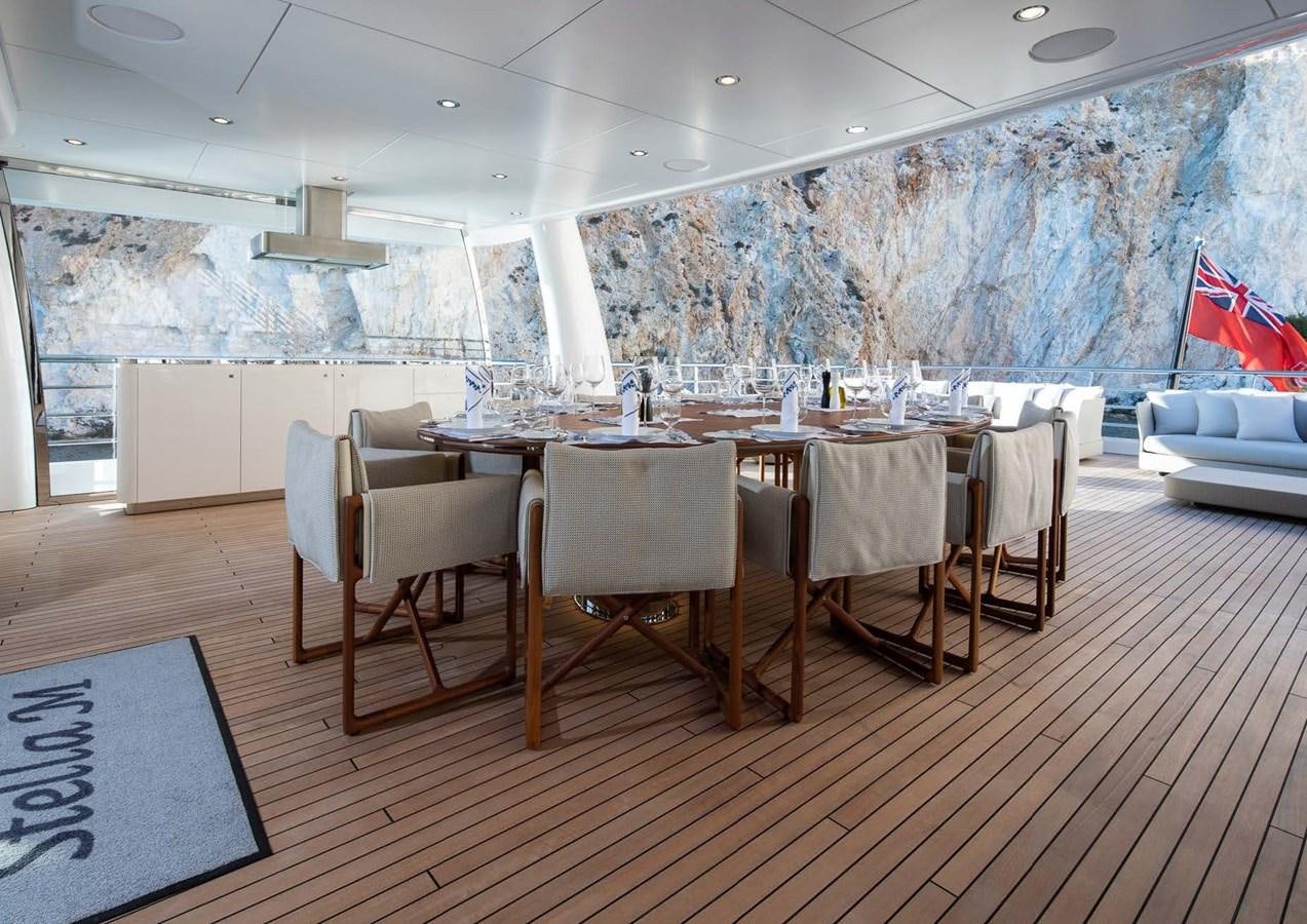 a room with a table and chairs aboard STELLA MI Yacht for Sale