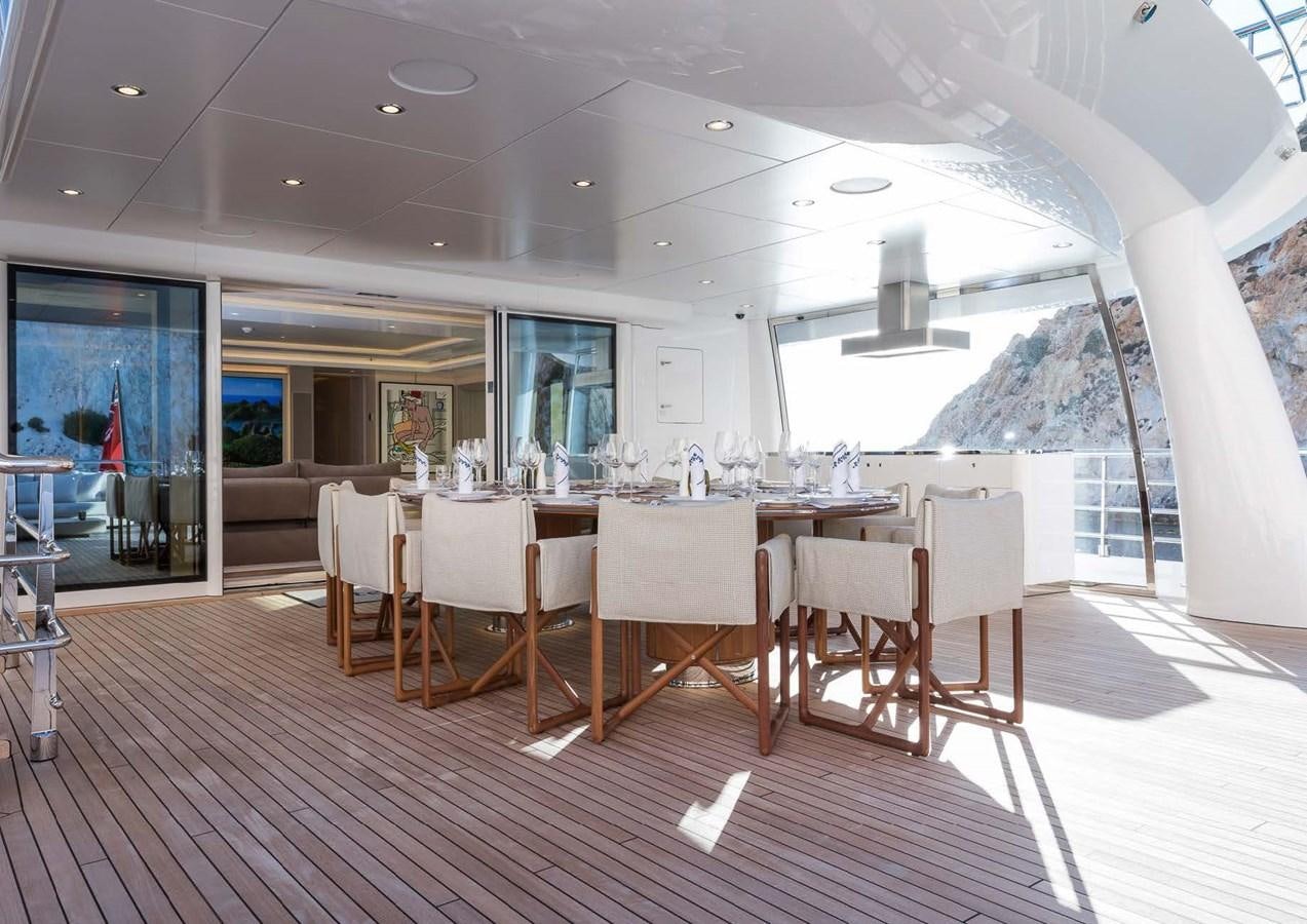 a large room with a table and chairs aboard STELLA MI Yacht for Sale