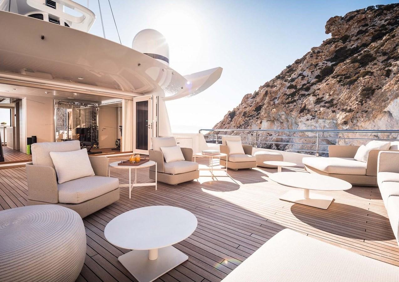 a modern living room with a large open roof aboard STELLA MI Yacht for Sale