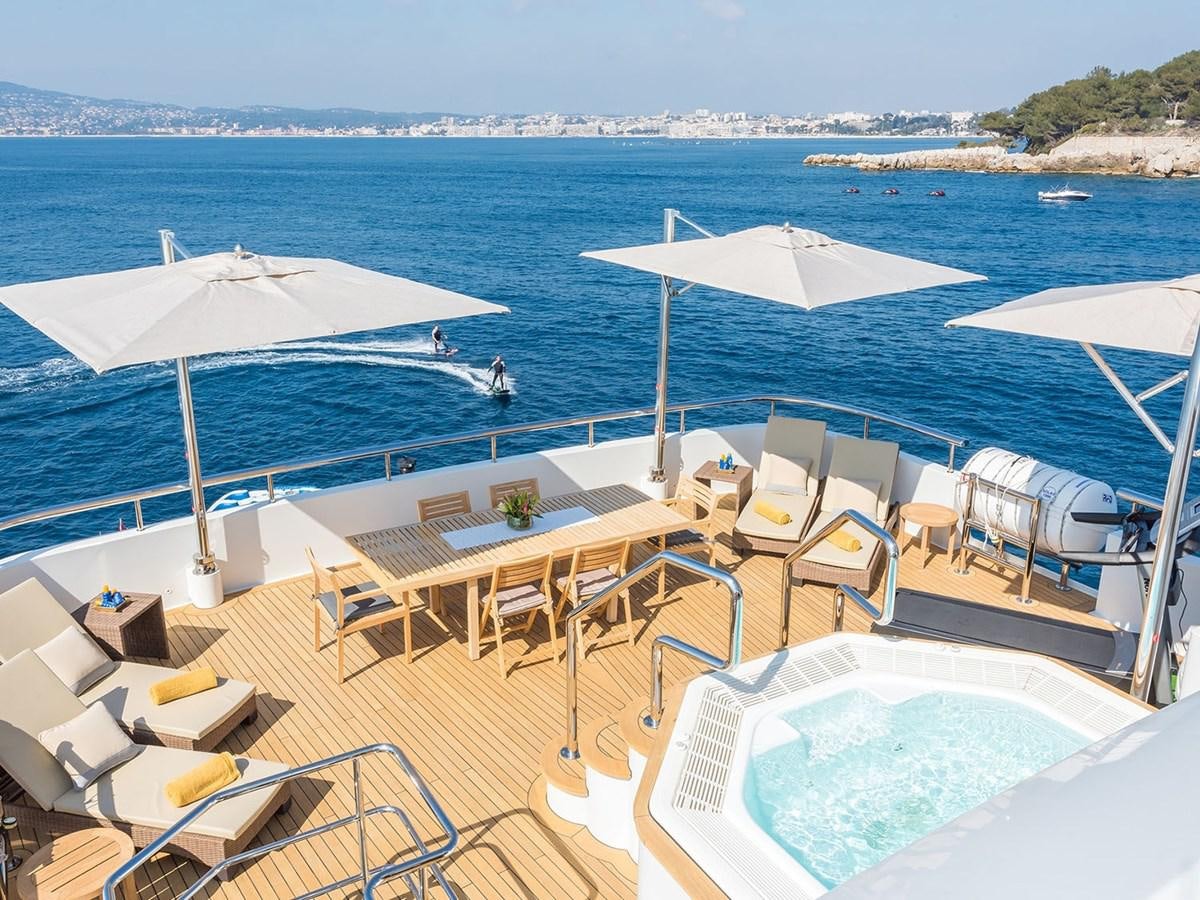 a deck with chairs and umbrellas aboard JADE 959 Yacht for Sale