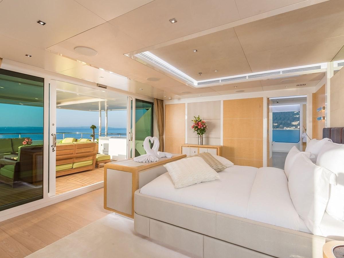 a room with a couch and a table aboard JADE 959 Yacht for Sale