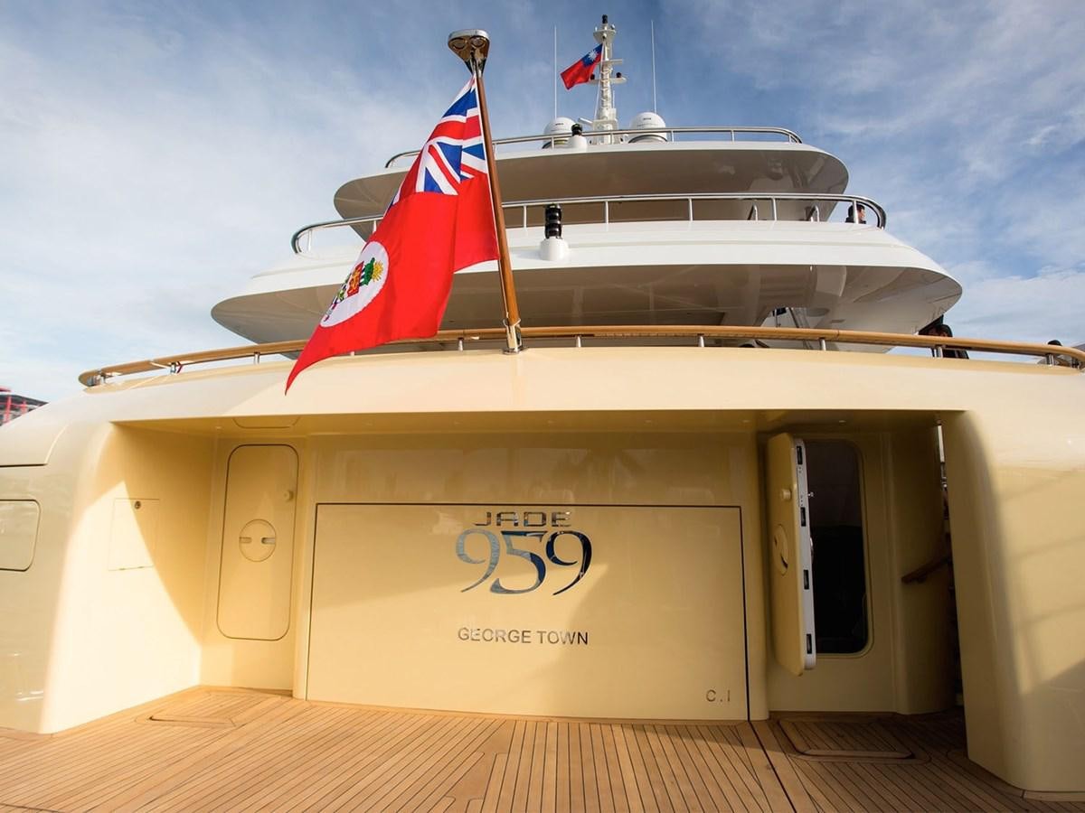 a boat with a flag on the front aboard JADE 959 Yacht for Sale