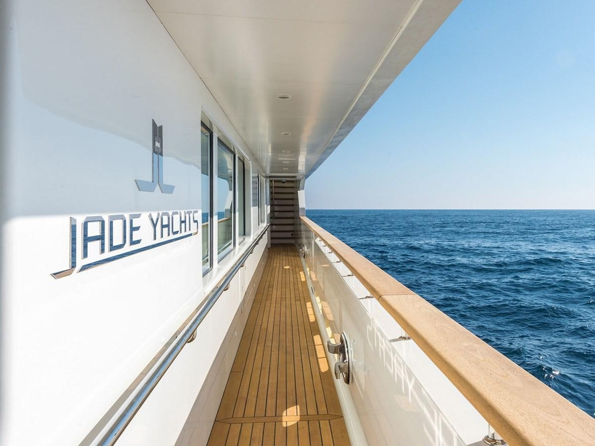 a long boardwalk leading to a building aboard JADE 959 Yacht for Sale