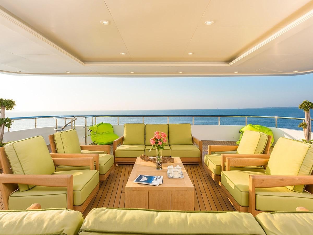 a living room with yellow couches aboard JADE 959 Yacht for Sale