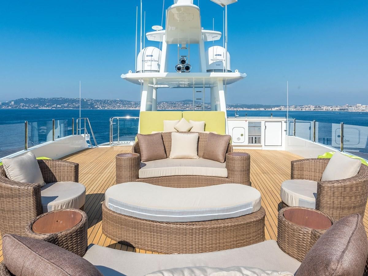 a room with a large white bed and a large white table with a white pillow on it and aboard JADE 959 Yacht for Sale