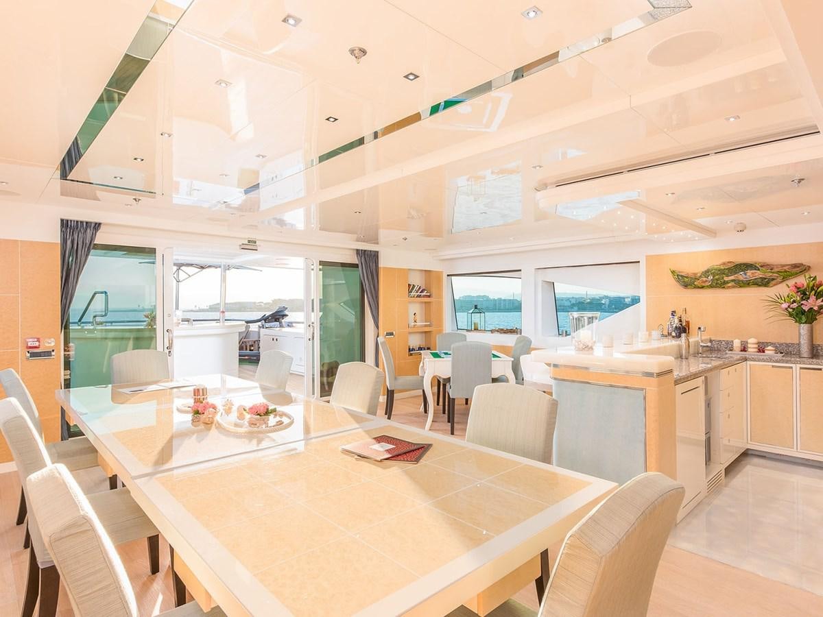 a large room with tables and chairs aboard JADE 959 Yacht for Sale