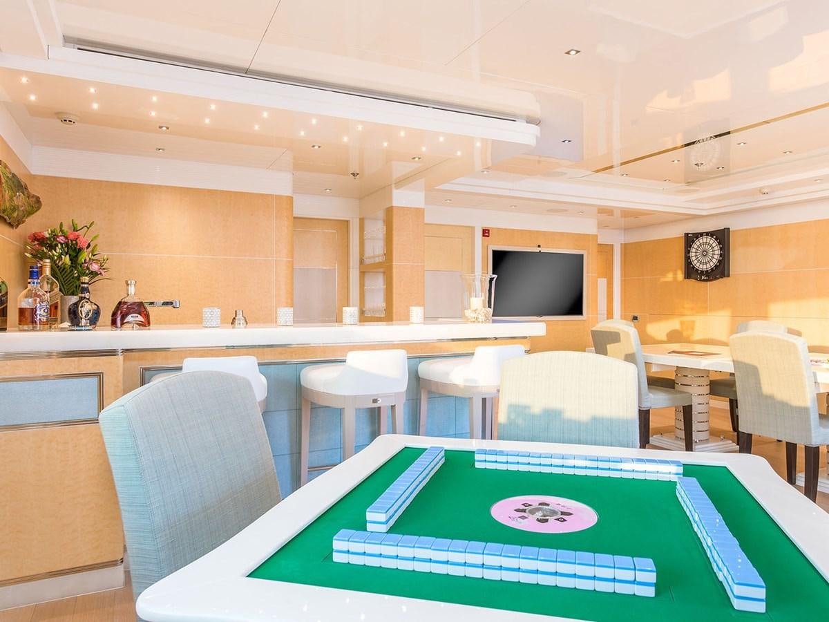 a room with tables and chairs aboard JADE 959 Yacht for Sale