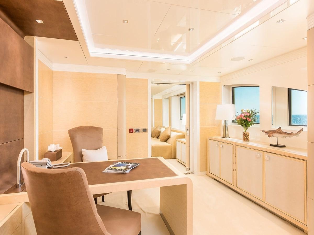 a living room with a table and chairs aboard JADE 959 Yacht for Sale