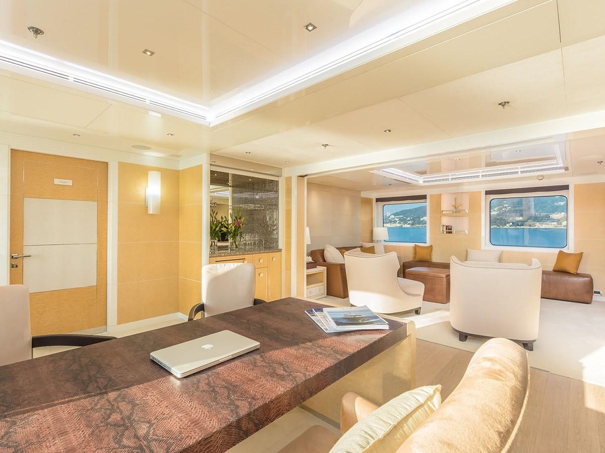 a large living room with a large table and chairs aboard JADE 959 Yacht for Sale