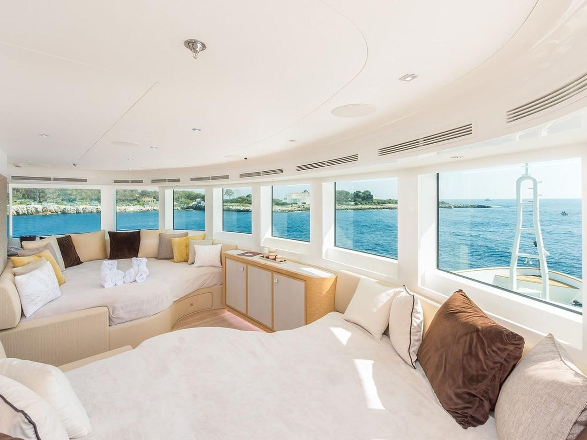 a room with a bed and a table aboard JADE 959 Yacht for Sale