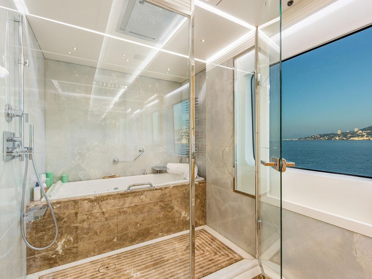 a bathroom with a tub and a shower aboard JADE 959 Yacht for Sale