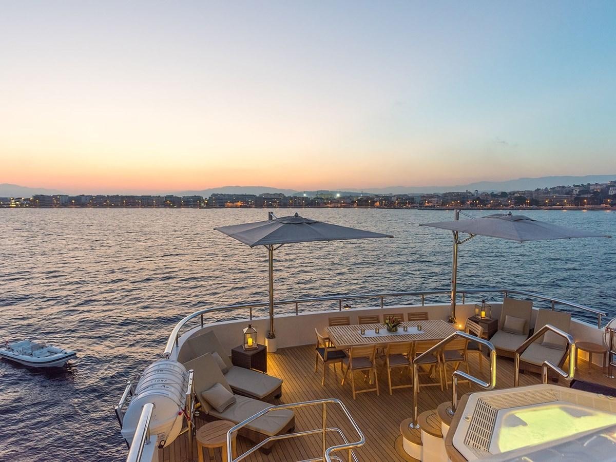 a boat dock with chairs and umbrellas aboard JADE 959 Yacht for Sale
