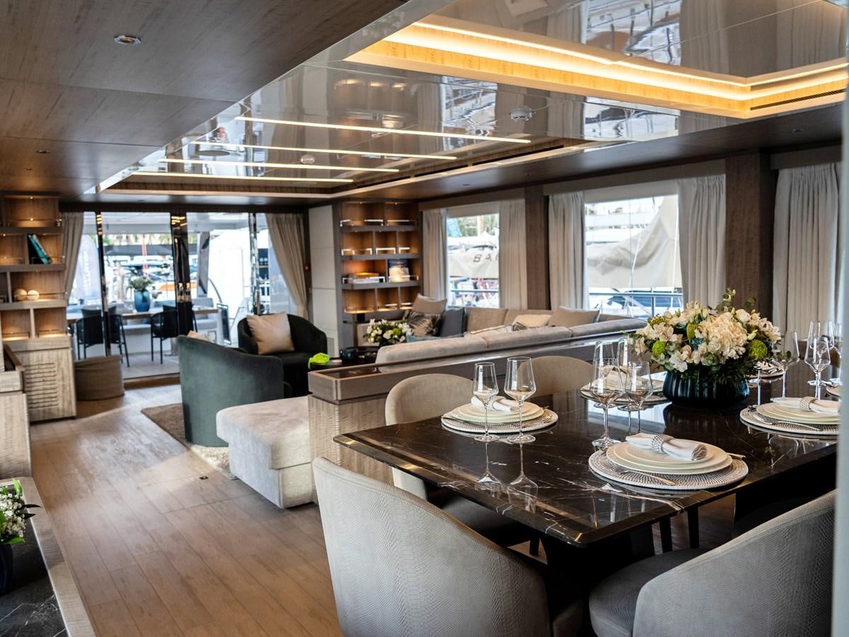 a large living room with a large table and chairs aboard NIXTUN Yacht for Sale