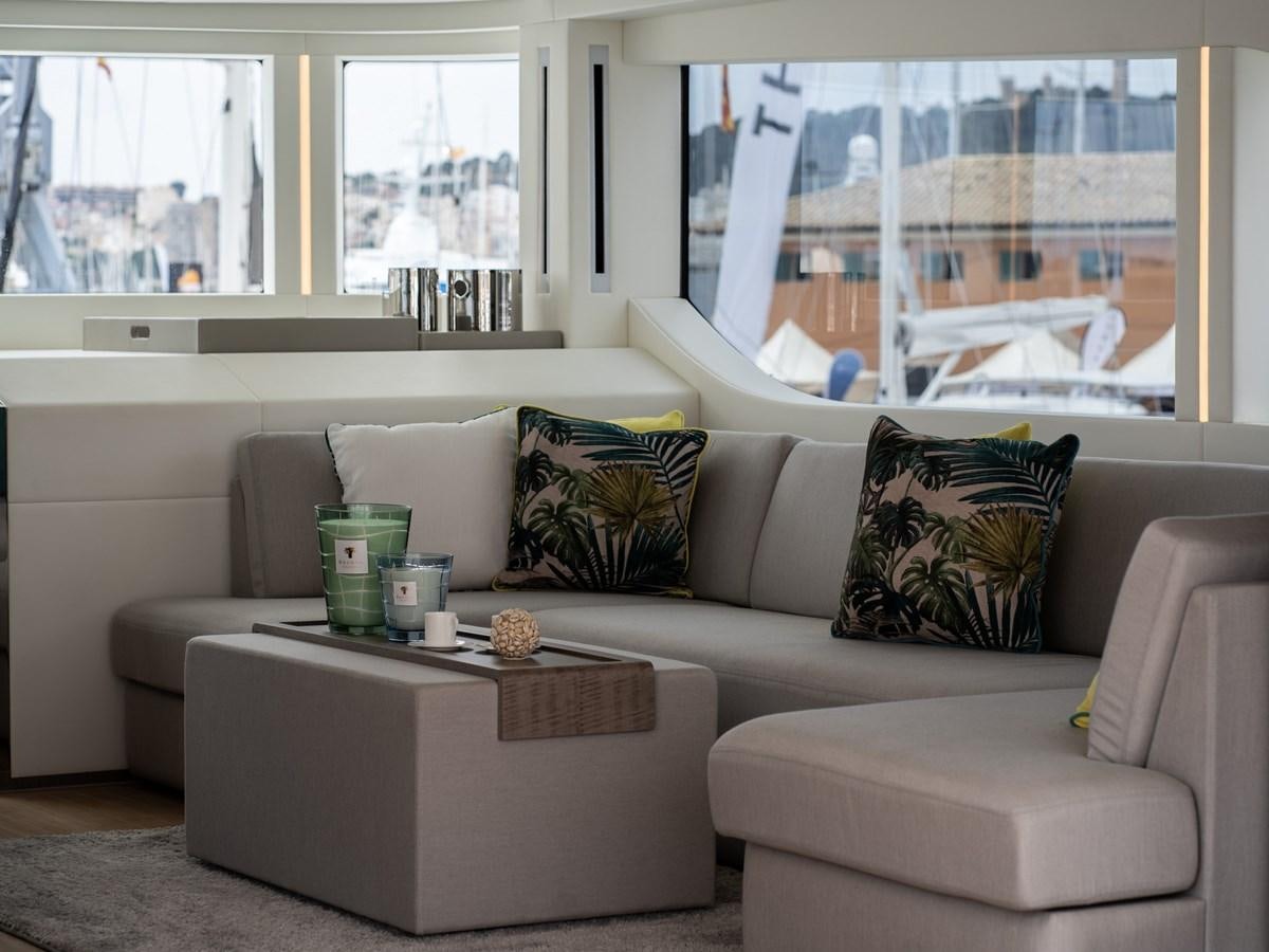 a couch with pillows and coffee table aboard NIXTUN Yacht for Sale