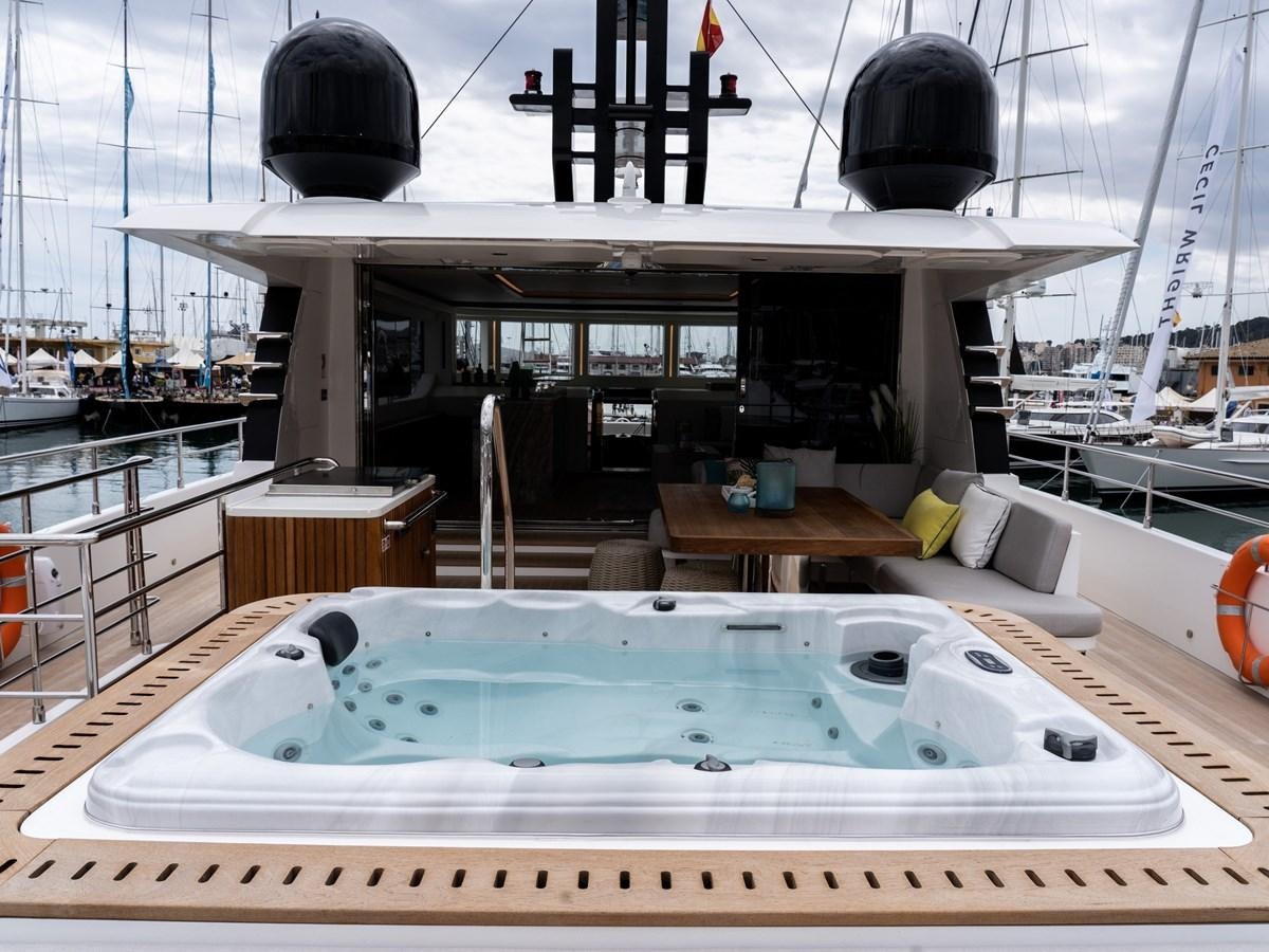 a large pool with a large white platform and a large black object on top aboard NIXTUN Yacht for Sale