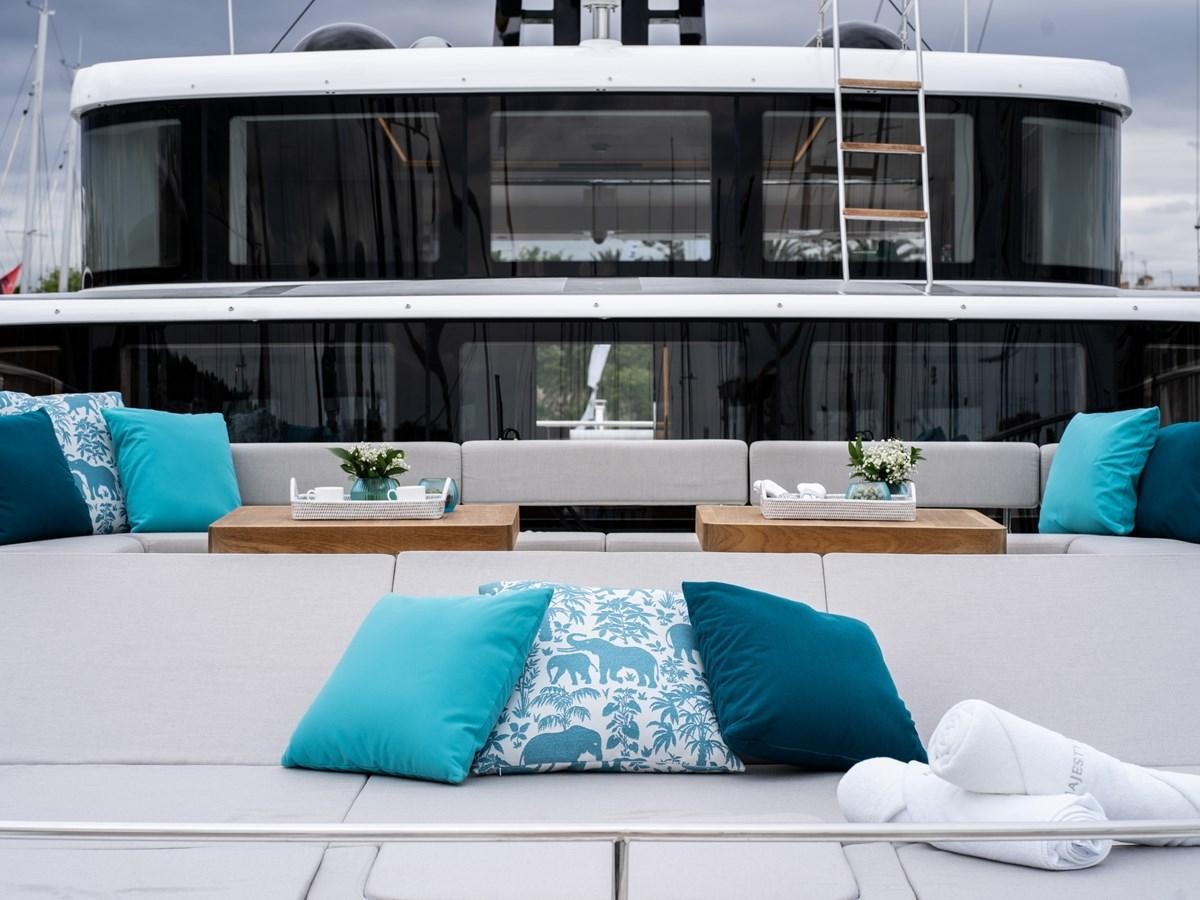 a white couch with blue pillows aboard NIXTUN Yacht for Sale