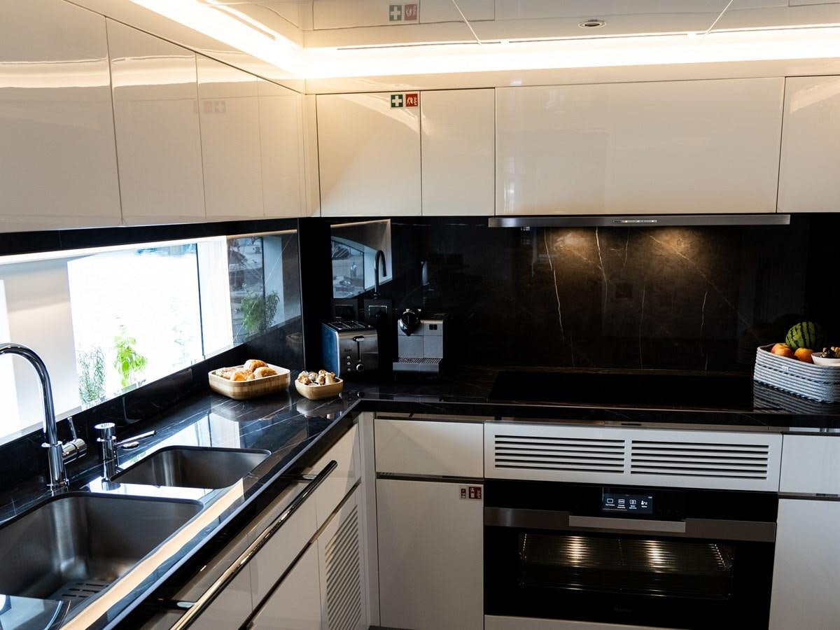 a kitchen with white cabinets aboard NIXTUN Yacht for Sale
