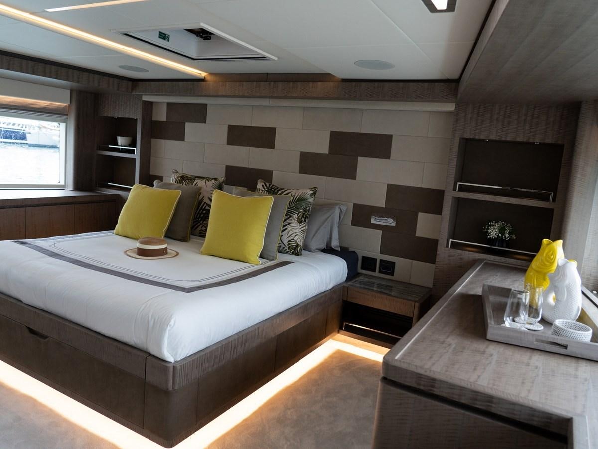 a bedroom with a bed and a table aboard NIXTUN Yacht for Sale
