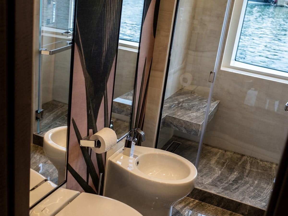 a bathroom with a tub sink and toilet aboard NIXTUN Yacht for Sale