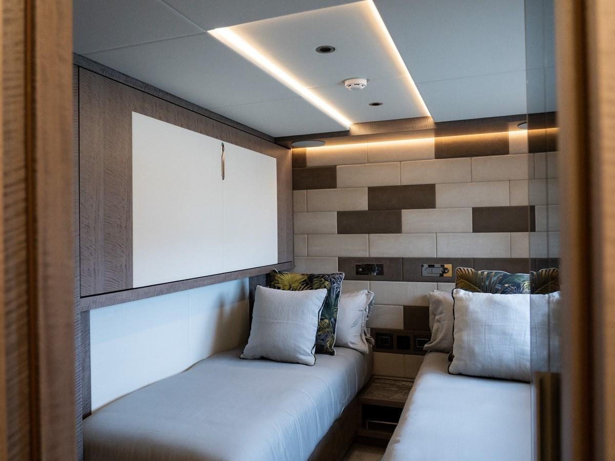 a room with a bed and a wall mounted television aboard NIXTUN Yacht for Sale