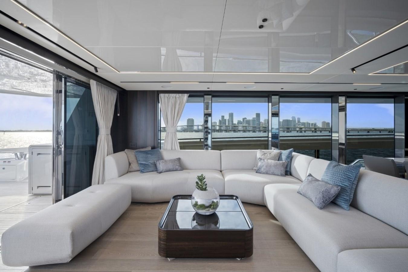 a living room with a large window aboard SUNSEEKER 90/25 Yacht for Sale