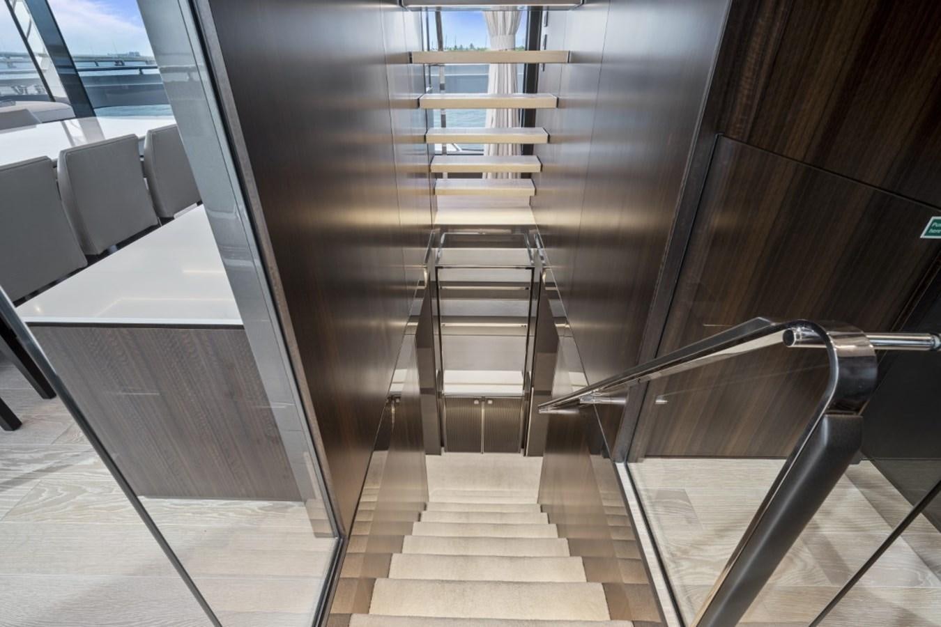 a staircase with a glass railing aboard SUNSEEKER 90/25 Yacht for Sale