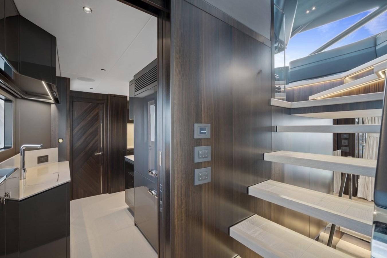 a room with a wood door and a glass wall aboard SUNSEEKER 90/25 Yacht for Sale