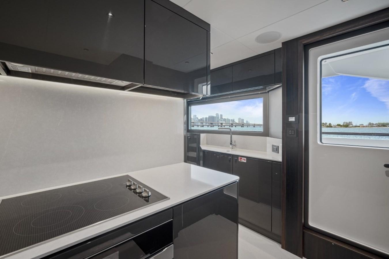 a kitchen with a large window aboard SUNSEEKER 90/25 Yacht for Sale