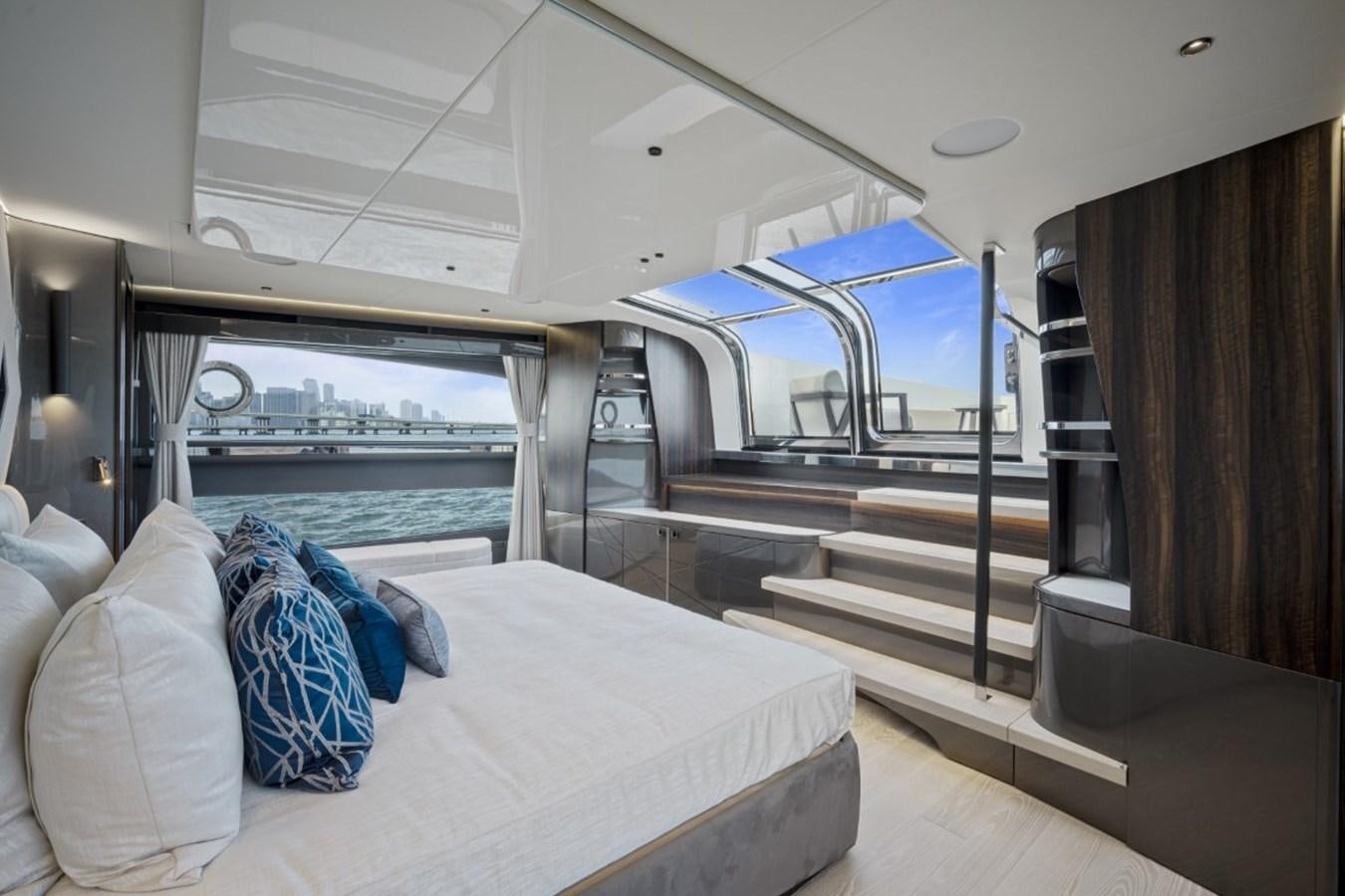 a room with a bed and a view of the water aboard SUNSEEKER 90/25 Yacht for Sale