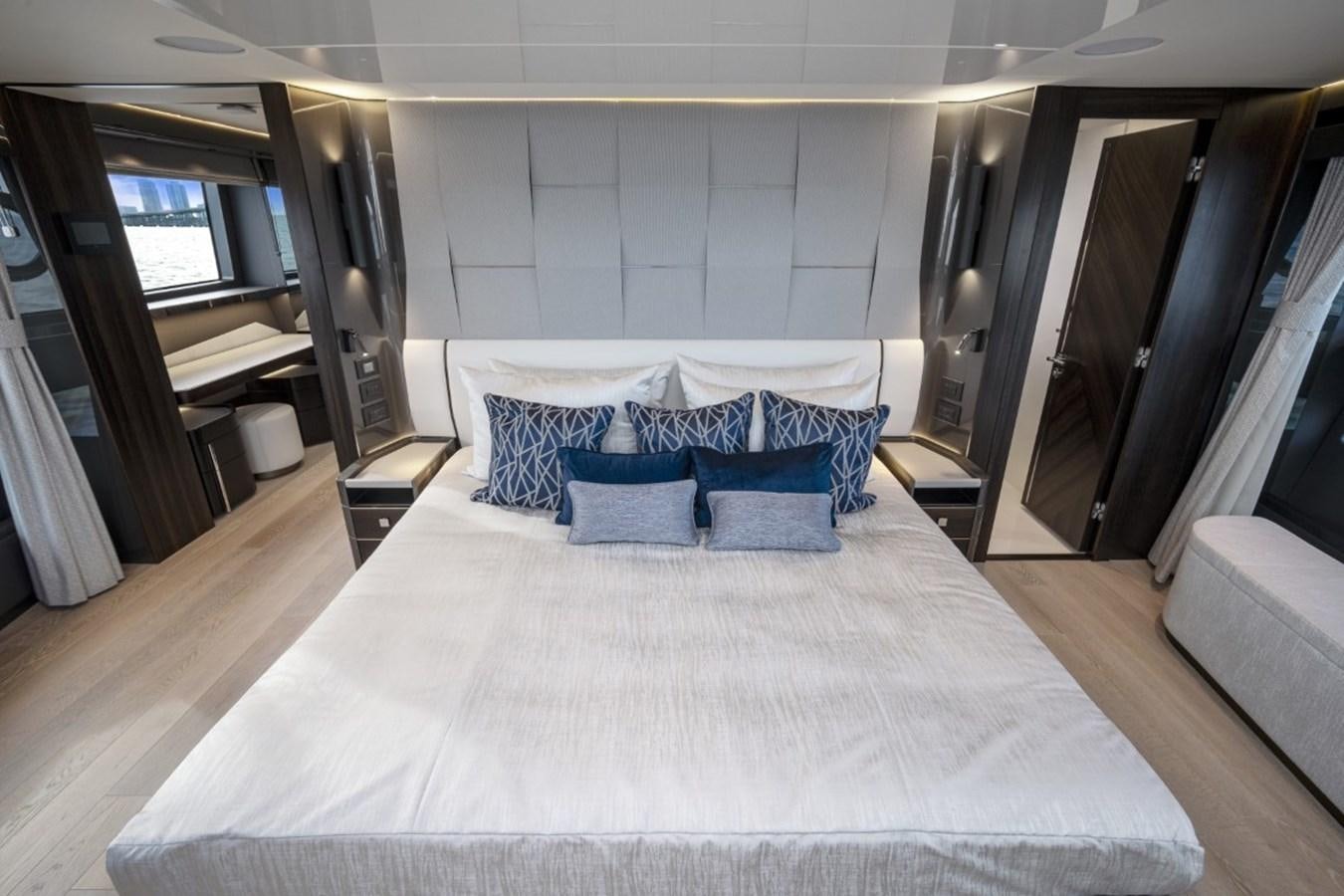 a large bed with white sheets aboard SUNSEEKER 90/25 Yacht for Sale