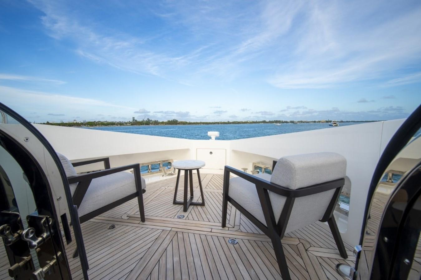 a deck with chairs and a table on it aboard SUNSEEKER 90/25 Yacht for Sale
