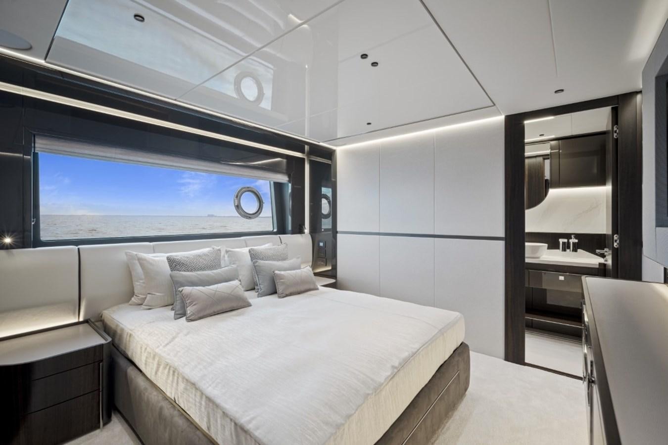 a room with a bed and a large screen aboard SUNSEEKER 90/25 Yacht for Sale